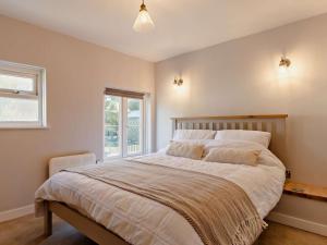 a bedroom with a large bed and a window at 2 Bed in Polruan 91015 in Polruan