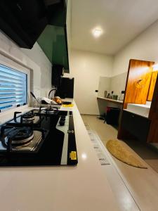 a kitchen with a stove top oven sitting on a counter at ThunderHill by Casablanca - A Premium Pool Villa in Meenangadi