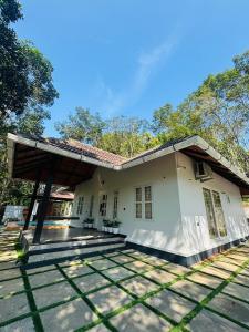 a small white house with a roof at ThunderHill by Casablanca - A Premium Pool Villa in Meenangadi