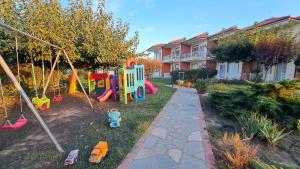a backyard with a playground with a play set at Daniel Studios in Kallithea Halkidikis