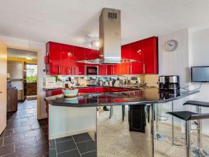 a kitchen with red cabinets and a large kitchen island at 2 Bed in Polruan 75740 in Polruan +15 photos
