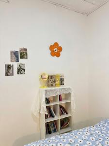 a bedroom with a bed and a shelf with books at Nap House 2- house in center Phan Thiet in Ấp Bình Hưng