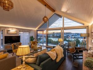 a living room with a couch and a large window at 5 Bed in Polruan 93849 in Polruan