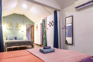 a bedroom with two beds and a room with two beds at Beach front cottage in Haad Pleayleam