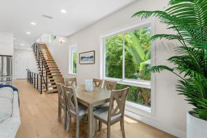 a dining room with a table and chairs and a window at 30 8th Avenue in Indialantic