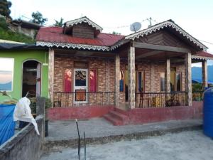 a small house with a red roof at Peshok Subba Homestay By StayApart in Darjeeling
