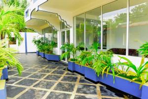 a lobby of a building with potted plants at Royal Beach Hotel in Trincomalee