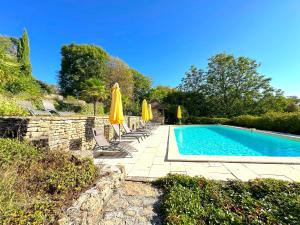 a swimming pool with lounge chairs and umbrellas at Clos de Fougères - Cocon in Montoillot +6 photos