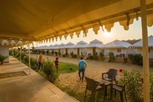 a group of people playing with a soccer ball in a courtyard at The Saffron Desert Camp, Jaisalmer in Jaisalmer