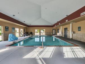 a large swimming pool in a large room at Platinum Inn & Suites Webster in Webster