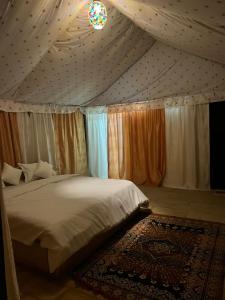 a bedroom with a bed in a tent at Taj heritage camp& resort in Jaisalmer