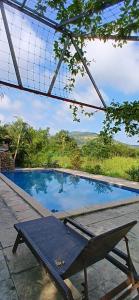 a picnic table in front of a swimming pool at Cocorico Stay Ya! Cottages Alibag in Alibaug