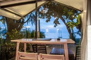 a table and chairs with a view of the ocean at Beach front cottage in Haad Pleayleam