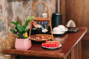 a table with a plant and plates of food on it at Tam Cốc Valley Eco Resort in Ninh Binh