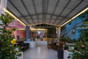 a restaurant with tables and chairs and plants at Haishu Yuntian 