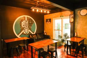 a restaurant with tables and a couch in a room at Crashpalace Backpackers in Rotorua