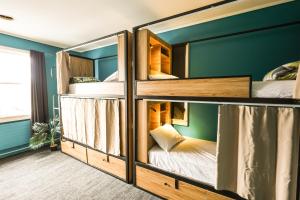a room with four bunk beds in it at Crashpalace Backpackers in Rotorua +53 photos