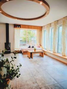 a large room with a bed and a table at Ma-Bebe Play House with Private Sauna --- Lake, Parks and SPA Pools in 5 min in Pancharevo