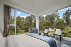 a bedroom with a bed and a large window at Haishu Yuntian  +41 photos