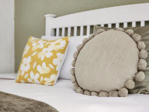 a pillow is sitting on a bed with pillows at 70 on Brander in Cape Town +8 photos