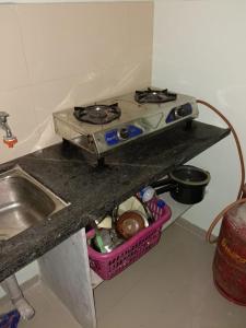 einen Herd mit Backofen auf einer Küchentheke in der Unterkunft 1 big furnished studio apartment with a pantry including fridge, utensils, gas stove and a washing machine with attached bathroom that can accommodate minimum 4 people in Igatpuri