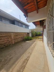 an outside view of a building with a porch at El Quisco cabaña con estacionamiento sector tranquilo in El Quisco +7 photos