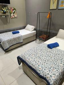 a room with two beds in a room at Desa Besut Inn in Kuala Besut