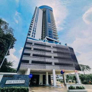 a tall building with a sign in front of it at The Straits Suites & Residences in Johor Bahru