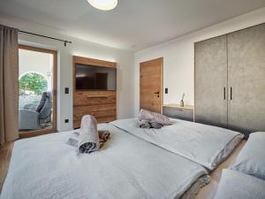 a bedroom with two beds and a television in it at Lodge am Wetterstein in Ehrwald