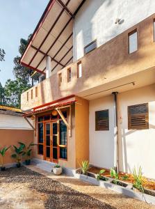 a house with a porch with plants in front of it at Montes Ella in Ella