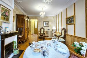 a dining room with a table with dishes on it at Le Clos De Saint Seurin in Bordeaux