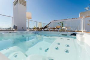 a hot tub on the roof of a building at INMalaga Luxury Penthouse Nueva 3 in Málaga