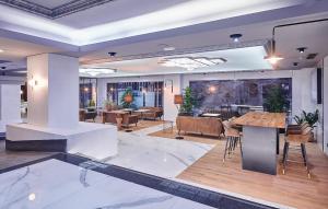 a lobby with tables and chairs in a building at Gran Hotel Luna de Granada in Granada