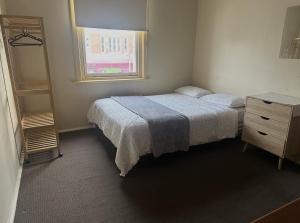 a bedroom with a bed and a dresser and a window at Ararat Hotel in Ararat +17 photos