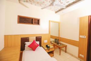 a hotel room with a bed and a mirror at Hotel Lav-kush Deluxe 2 Min From New delhi Railway Station in New Delhi
