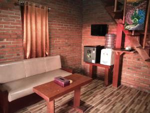 a living room with a couch and a coffee table at D'Tebe House Kelating in Tabanan