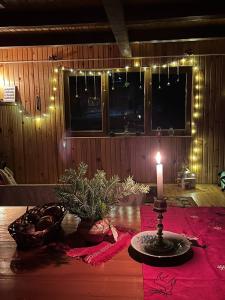 a candle sitting on top of a table with lights at Те Село in Velyka Volosyanka