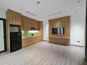 a large room with a television and wooden walls at Minerva Aparthotel Hanoi in Hanoi