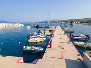 a group of boats docked at a dock in the water at Elegant Dream Suites in Ayia anna