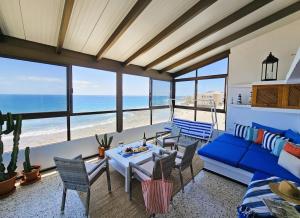 a living room with a blue couch and a table at La Gaeta 1,Views above the Ocean in Telde