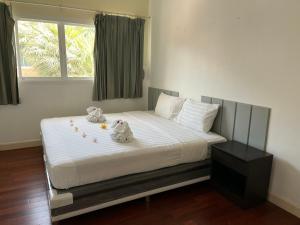 a bedroom with a bed with stuffed animals on it at Kata beach at pool house in Kata Beach