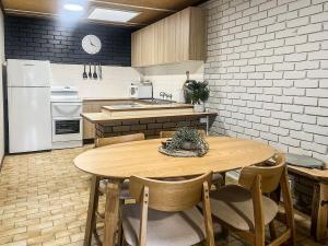 a kitchen with a wooden table and a white refrigerator at Unit 11, 6-8 Buckland Drive, Mallacoota in Mallacoota +12 photos