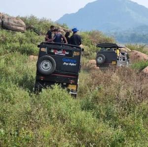 a group of people riding on top of a jeep at Elephant View Hotel in Damana