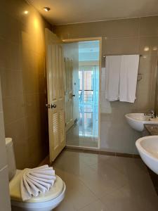 a bathroom with two sinks and a toilet with towels at Kata beach at pool house in Kata Beach +24 photos