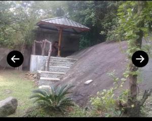 a gazebo with two arrows in front of it at Elephant View Hotel in Damana
