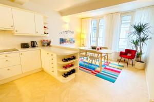 a kitchen with a table and a dining room at F1 Experience Lodge Spa-Francorchamps in Malmedy +8 photos