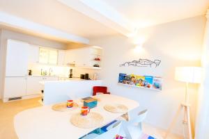 a kitchen with a table and two chairs in a room at F1 Experience Lodge Spa-Francorchamps in Malmedy