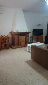 a living room with a couch and a fireplace at Finca el abuelo in Carmona +5 photos