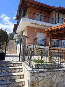 a house with stairs leading up to it at Dimitra's Little House in Petalidhion +36 photos