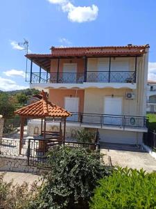 a large house with a gazebo in front of it at Dimitra's Little House in Petalidhion